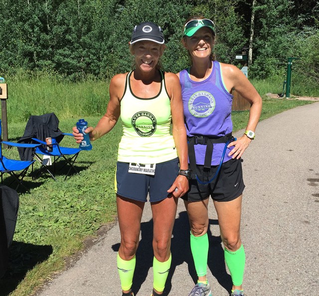 Photo of Patty Bryant and Becky Aaronson at an Aid Station during the Aspen Backcountry Marathon